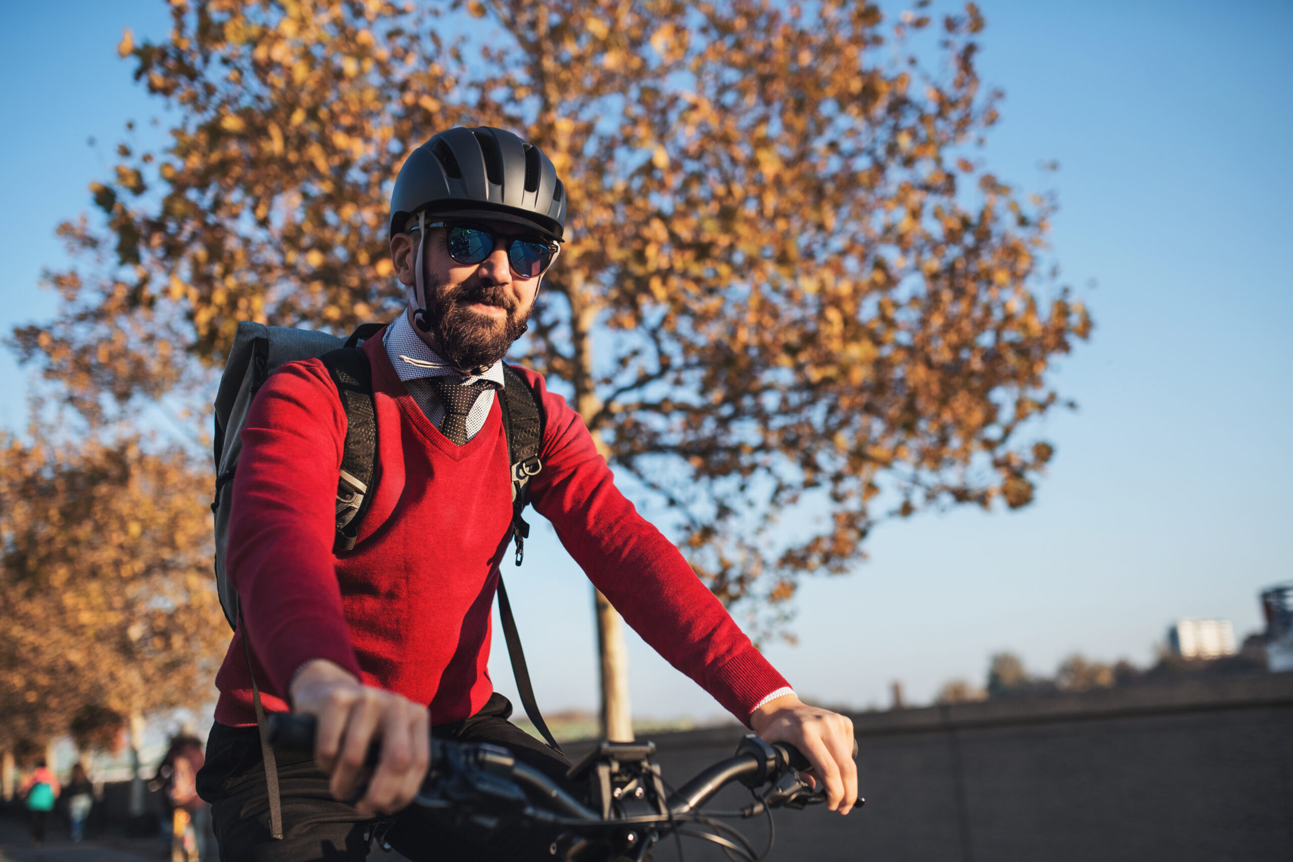Hipster businessman commuter with bicycle traveling to work in city.
